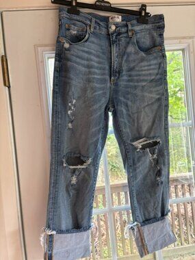 Agolde Size 30 Light wash heavily distressed knees and a raw cuffed hem.